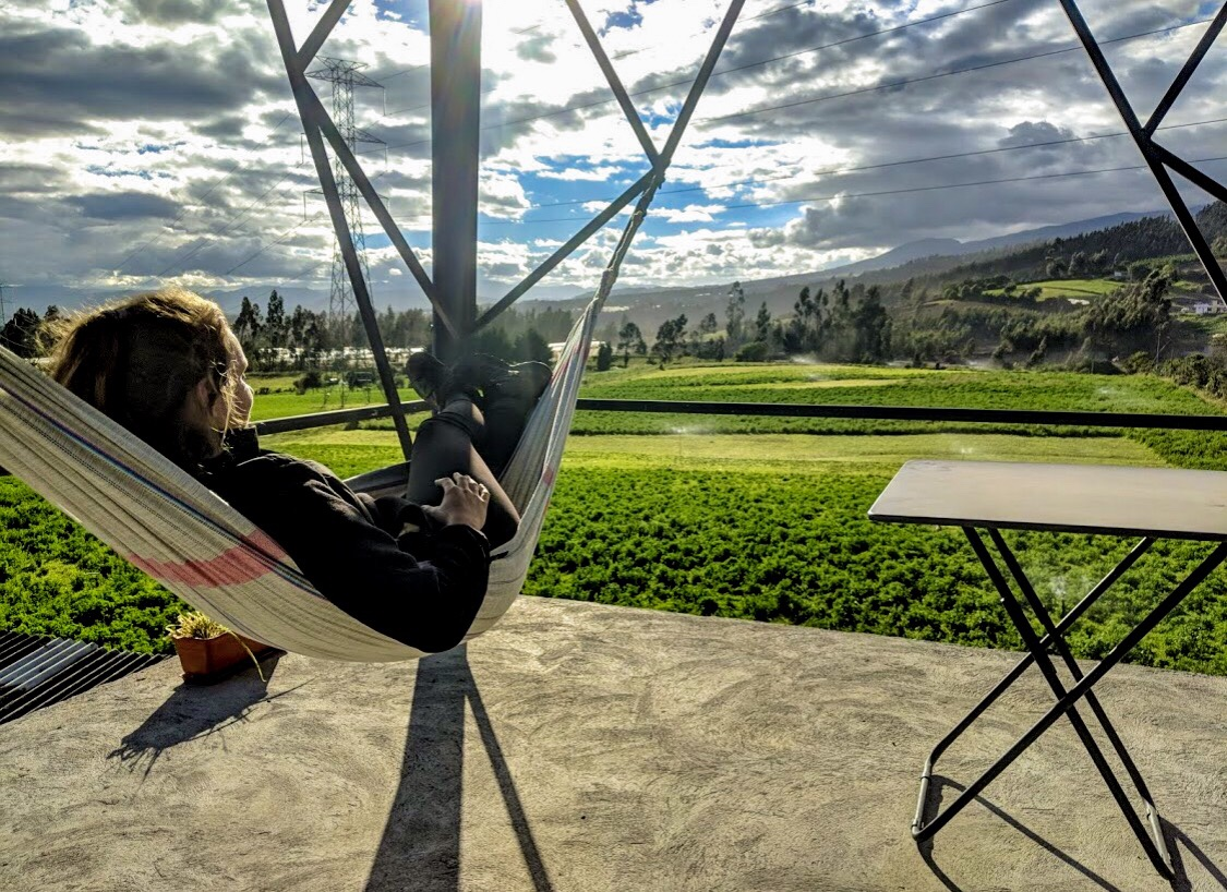 Guest relaxing in a hammock overlooking the countryside